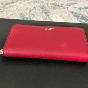 Kate Spade gently used red wallet with multiple inner compartments 8” x 4”
